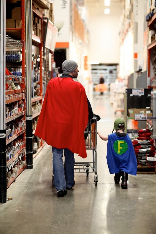 dad and son wearing super hero capes